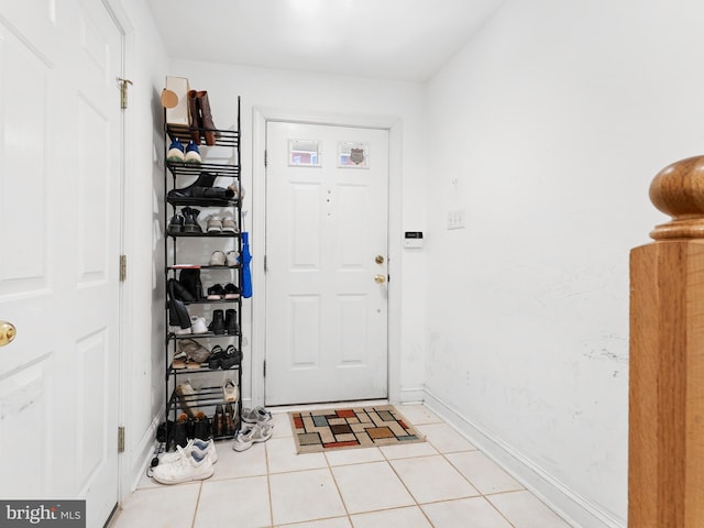 interior space featuring light tile patterned floors and baseboards