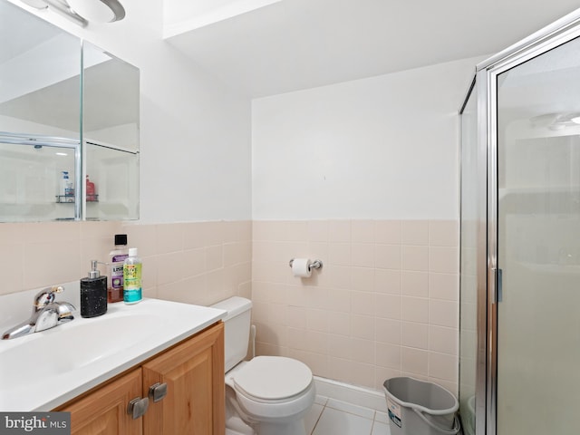 bathroom featuring vanity, tile patterned flooring, an enclosed shower, tile walls, and toilet