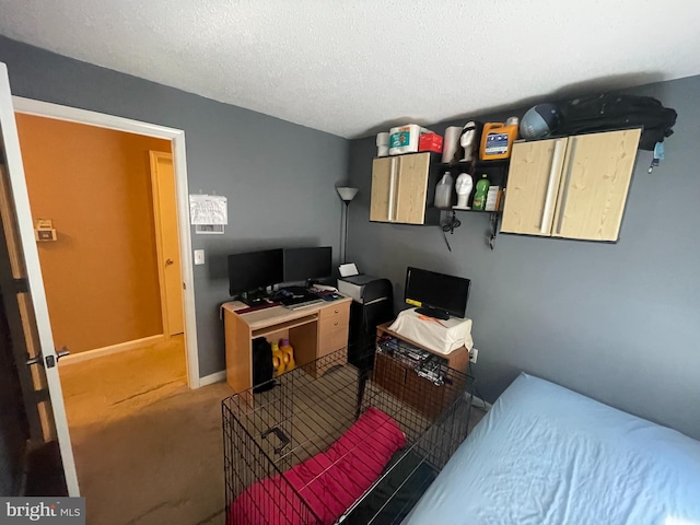 carpeted bedroom featuring a textured ceiling and baseboards