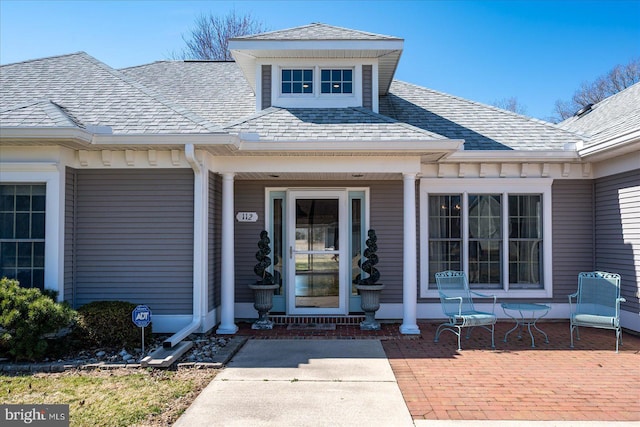 entrance to property with roof with shingles