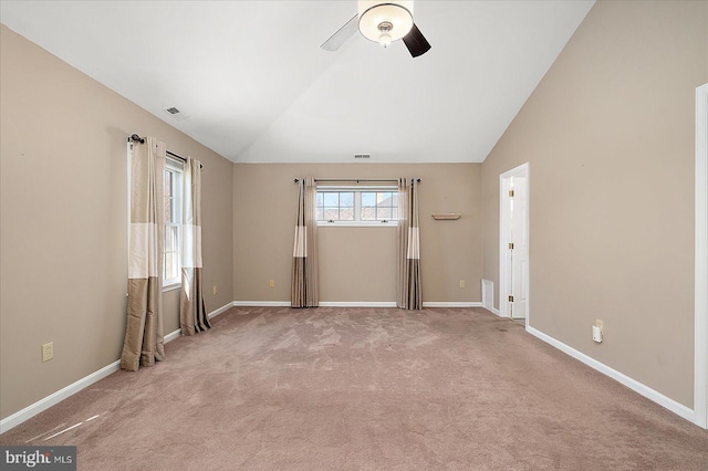 spare room with baseboards, lofted ceiling, carpet floors, and ceiling fan