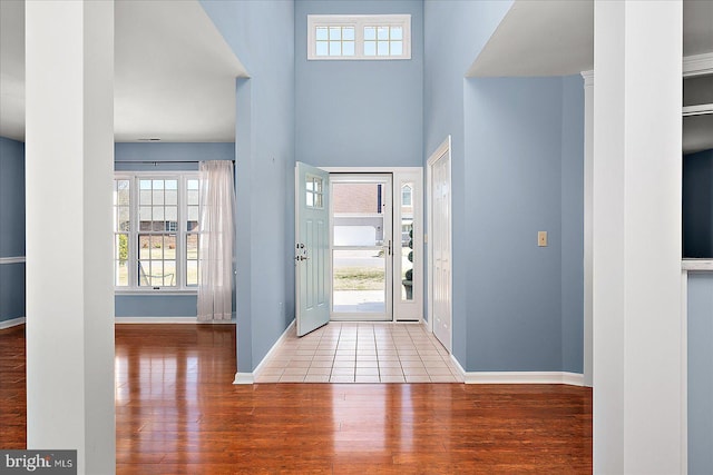 foyer with wood finished floors and baseboards