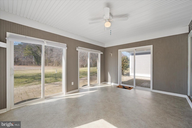 empty room with a ceiling fan and baseboards