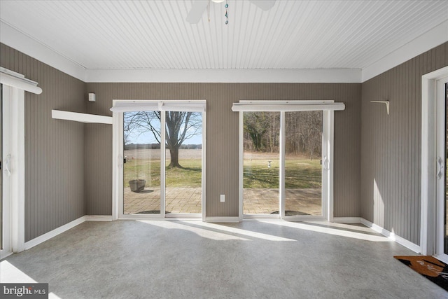 spare room featuring baseboards and a ceiling fan