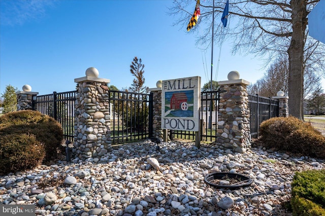 community sign with a gate and fence