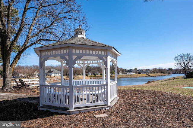 surrounding community with a gazebo and a water view