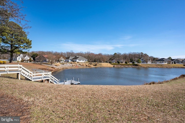 dock area with a residential view and a water view