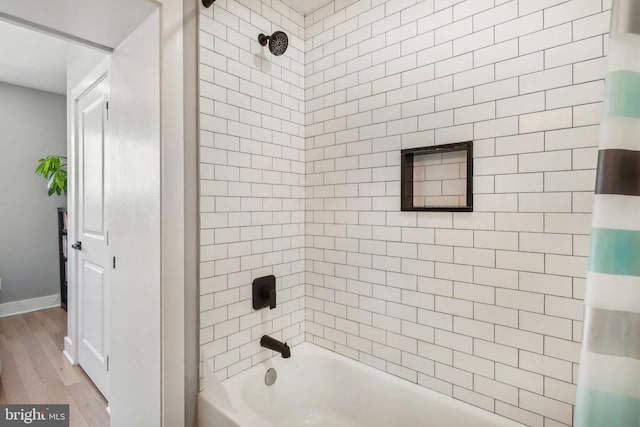 full bath with shower / bathing tub combination and wood finished floors