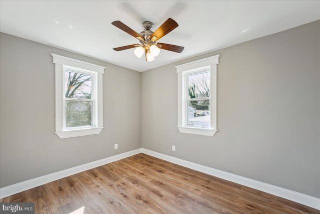 unfurnished room featuring ceiling fan, baseboards, and wood finished floors