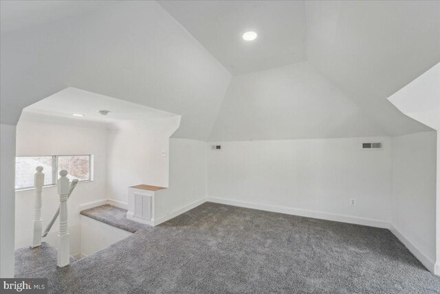 bonus room featuring vaulted ceiling, carpet flooring, and visible vents