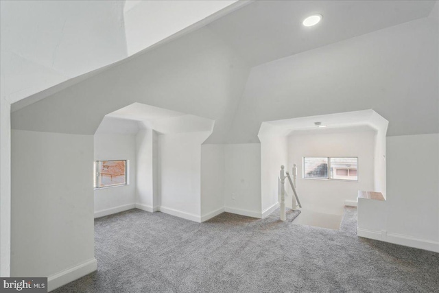 bonus room with lofted ceiling, carpet flooring, and baseboards