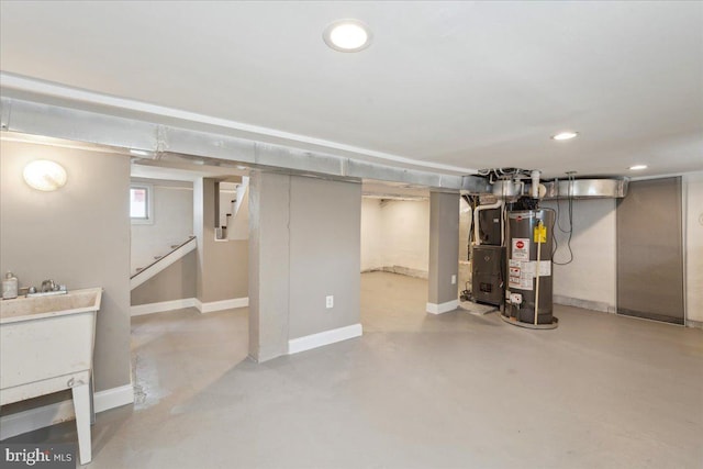 basement featuring baseboards, stairway, gas water heater, and recessed lighting