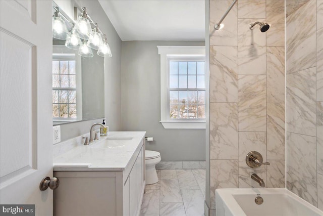 bathroom with baseboards, toilet, vanity, marble finish floor, and shower / bathtub combination