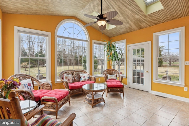 sunroom / solarium featuring visible vents, lofted ceiling, and a ceiling fan