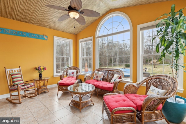 sunroom / solarium featuring vaulted ceiling, plenty of natural light, and a ceiling fan