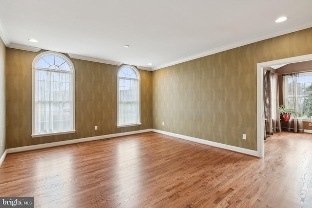 unfurnished room featuring recessed lighting, wood finished floors, baseboards, and ornamental molding