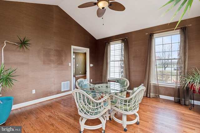 dining room with a wealth of natural light, visible vents, a ceiling fan, and wood finished floors