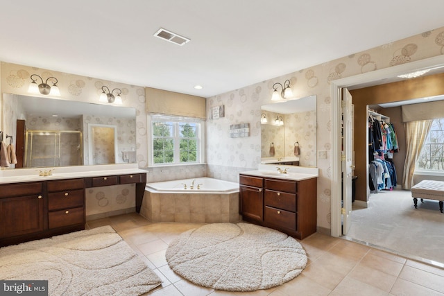 full bath with visible vents, a healthy amount of sunlight, a shower stall, and wallpapered walls