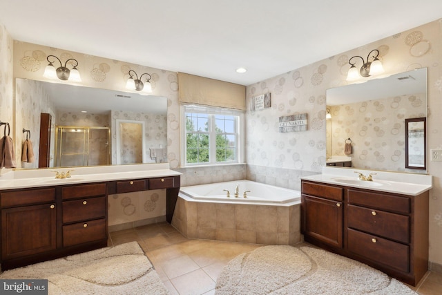 bathroom featuring a sink, a garden tub, a stall shower, and wallpapered walls