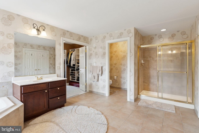 bathroom with wallpapered walls, toilet, and a stall shower