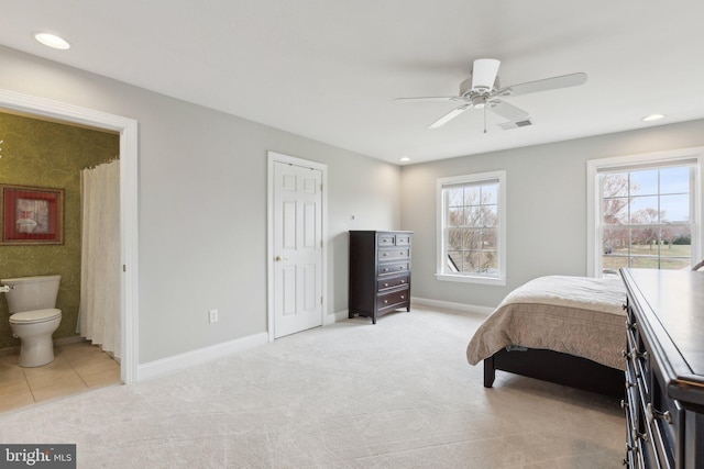 carpeted bedroom featuring visible vents, recessed lighting, ensuite bath, and baseboards