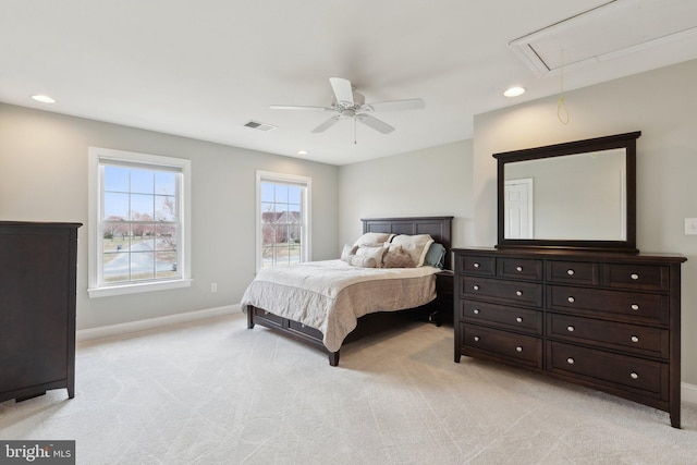 bedroom featuring attic access, baseboards, visible vents, and light carpet