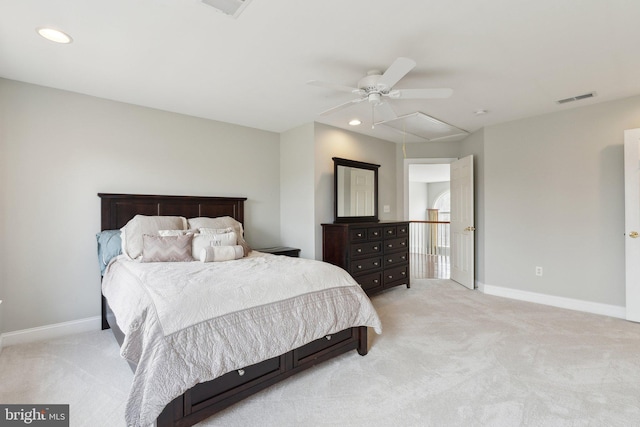 bedroom featuring light carpet, visible vents, attic access, and baseboards