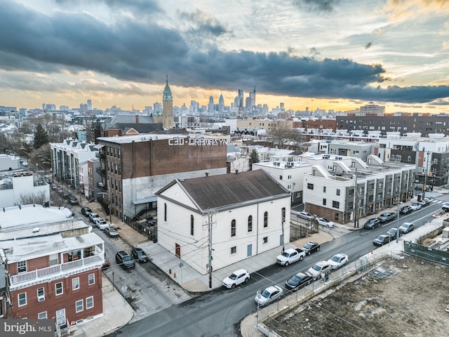 aerial view at dusk featuring a city view