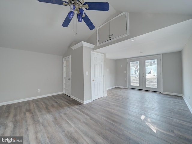 unfurnished living room featuring high vaulted ceiling, wood finished floors, a ceiling fan, baseboards, and french doors