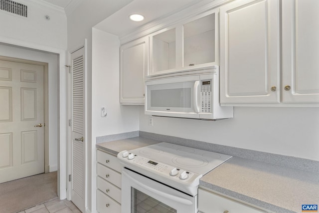 kitchen featuring white appliances, visible vents, light countertops, crown molding, and white cabinetry