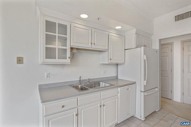 kitchen featuring white appliances, a sink, visible vents, white cabinets, and light countertops