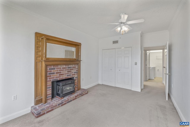 unfurnished living room featuring carpet floors, ornamental molding, and a textured ceiling