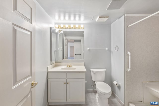 bathroom with baseboards, vanity, toilet, and tile patterned floors