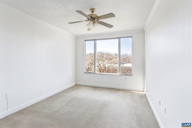 empty room featuring light carpet, ornamental molding, a textured ceiling, and baseboards