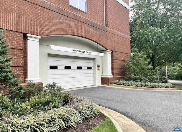 garage with aphalt driveway