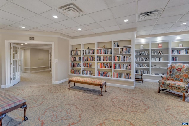 living area featuring carpet floors, recessed lighting, visible vents, and baseboards