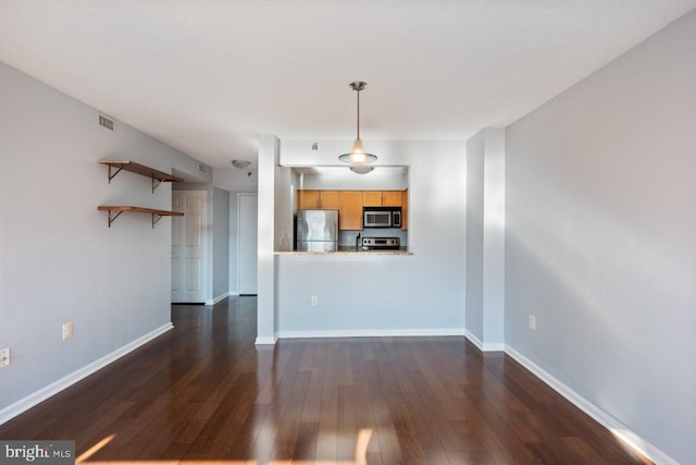 unfurnished living room with visible vents, baseboards, and dark wood-type flooring