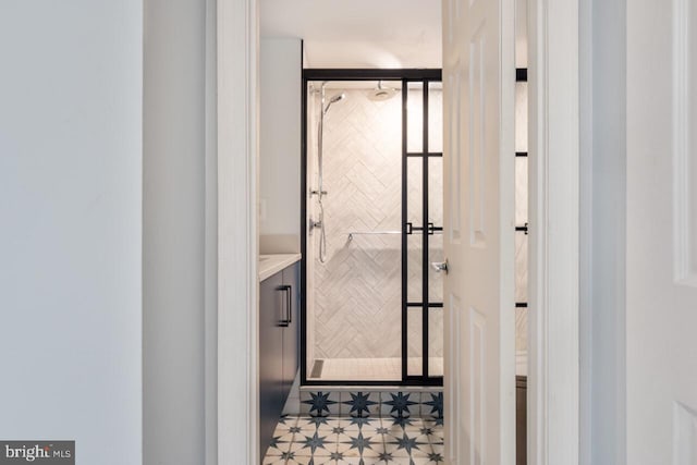 bathroom featuring a shower stall and vanity