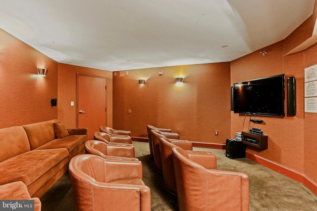 home theater featuring wallpapered walls, baseboards, and carpet flooring