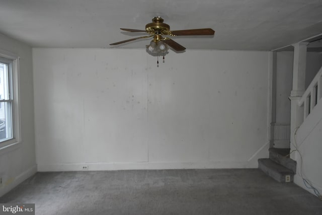 carpeted spare room featuring stairs