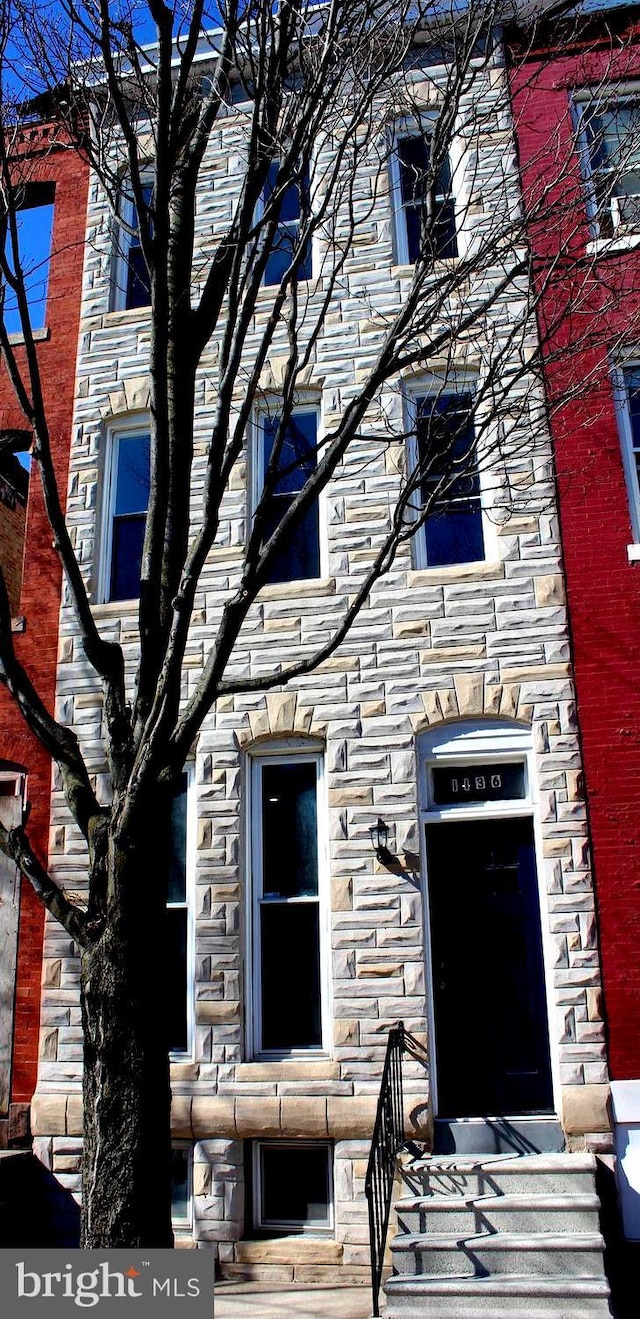 view of property featuring stone siding