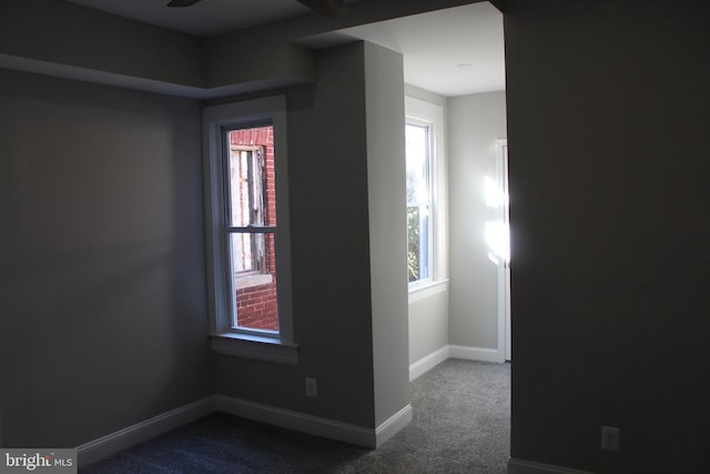 unfurnished room featuring carpet floors, a healthy amount of sunlight, and baseboards