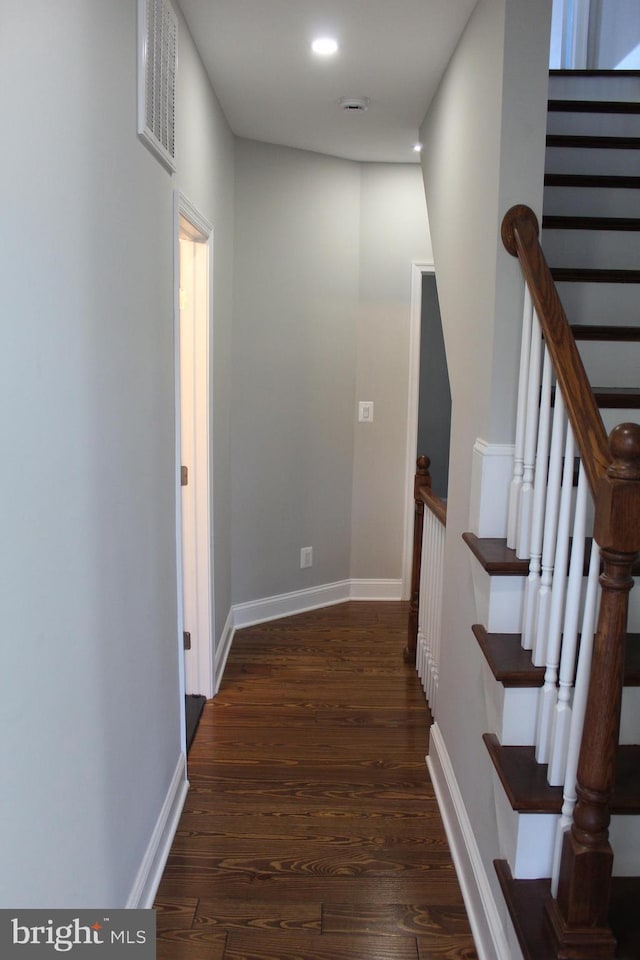 hall featuring baseboards, visible vents, stairway, wood finished floors, and recessed lighting