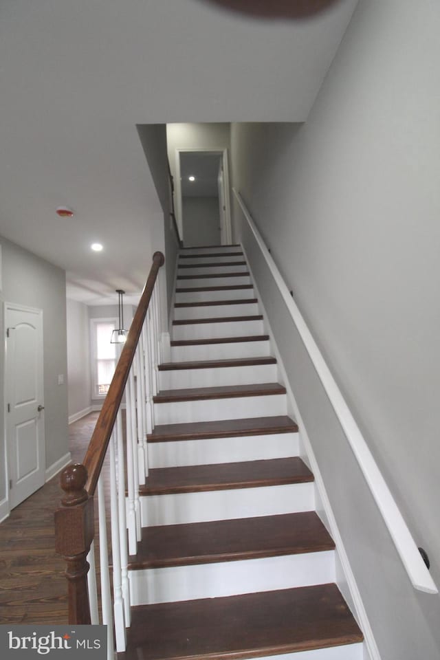 staircase with recessed lighting, baseboards, and wood finished floors