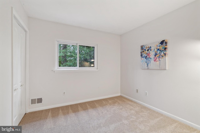 unfurnished bedroom featuring carpet floors, baseboards, and visible vents