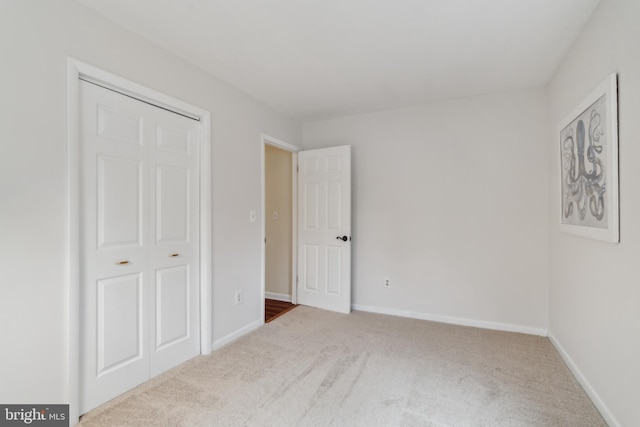 unfurnished bedroom featuring carpet and baseboards