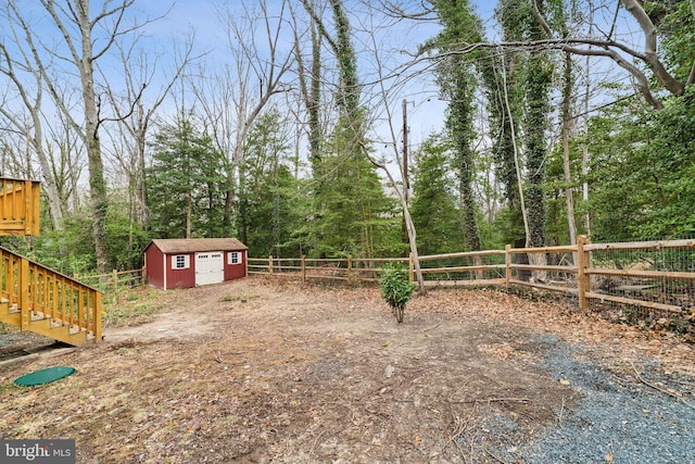 view of yard featuring a storage unit, an outdoor structure, and a fenced backyard