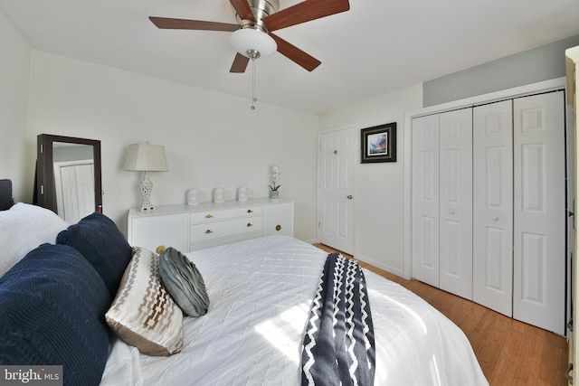 bedroom featuring light wood finished floors, a closet, a ceiling fan, and baseboards