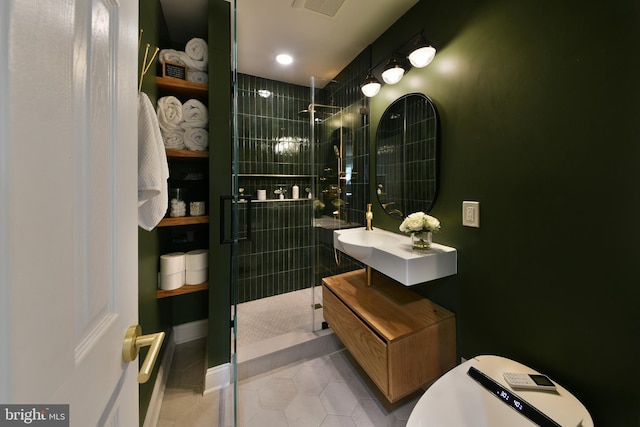 bathroom with tile patterned flooring, visible vents, tiled shower, and vanity