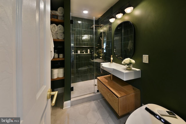 bathroom featuring tile patterned floors, a shower stall, and vanity